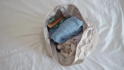 Packing a bag for a short trip to the beach Stock Footage 322957213