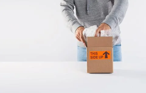 Packing A Box On Top Of A White Table Stock Photos