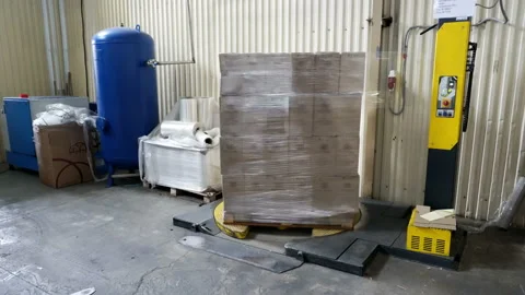 Packing of boxes with wine on a pallet in the polymeric film Stock Footage 102526631
