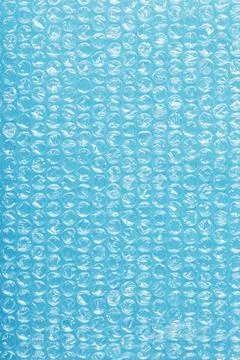 Packing bubble wrap for parcels on a blue background in full screen Foto stock