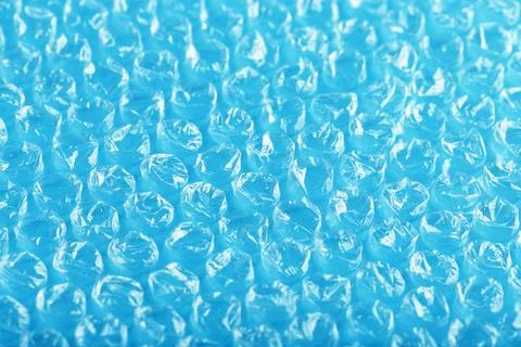 Packing bubble wrap for parcels on a blue background in full screen Stock Photos