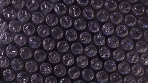 Packing bubble wrap. Slide shot of polyethylene packaging film texture. Slow  Stock Footage 244334814