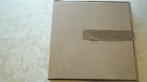 Packing the cardboard box of pizza using a scotch Stockbeeldmateriaal 63224597