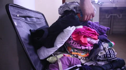 Packing clothes in suitcase Stock Footage