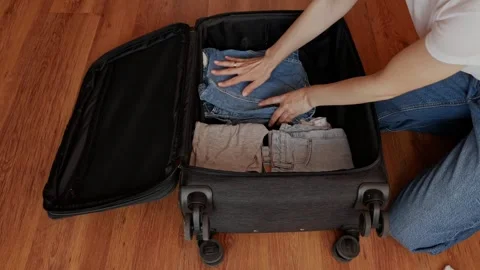 Packing clothes in a suitcase before going on vacation. Stock Footage 306936885