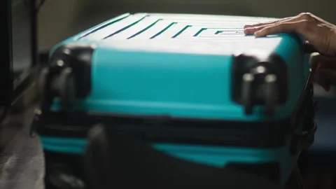 Packing Clothes into Teal Suitcase Stock Footage 344235831