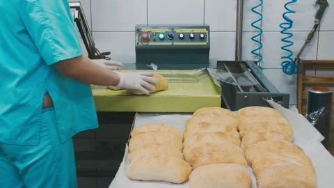 Packing conveyor. Packed long loaves of bread are moving on the conveyor. Stock Footage 126072255