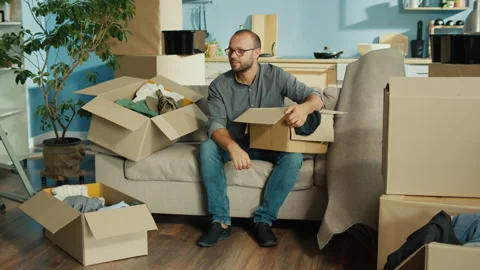Packing for a Fresh Start: Packing, and Saying Goodbye to Old Home Stock Footage 311579673