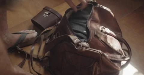 Packing Leather Holdall with Personal Items and Binoculars for Adventure Stock Footage 344348096