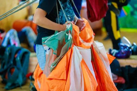 Packing a parachute into a backpack. Stock Photos