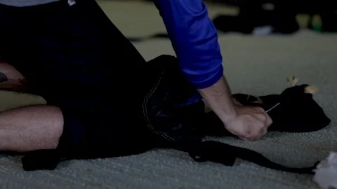 Packing parachute in deployment bag close up. Skydiver closing parachute contain Stock Footage 116491792
