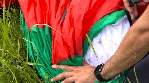Packing the Paraglider Wing After the End of the Flight. Hands Close-Up. Stock Footage 64603919