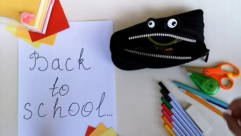 Packing pencil case Back to school,put in school stuff,give thumb-up.Time-lapse Stock Footage 114016600