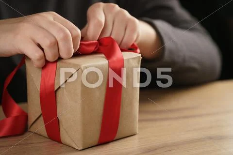 Packing presents with red ribbon Stock Photos
