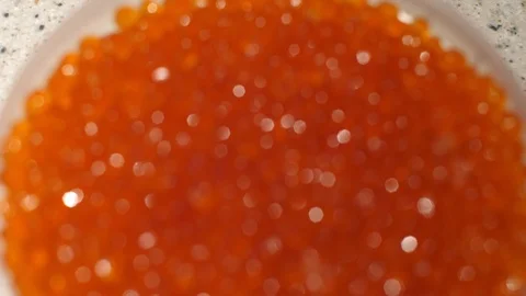 Packing red caviar shiny in the light. Plastic jar with red caviar of sea fish Stock Footage 119352562
