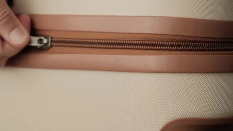 Packing for relocation. Close up of hands fastening suitcase zipper before Video stock 346248869
