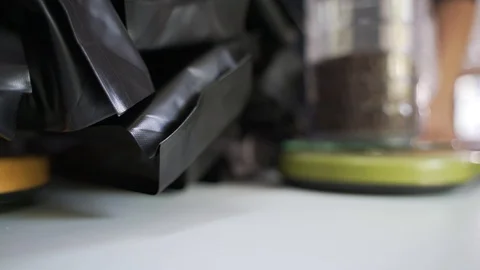 Packing roasted coffee beans to plastic bag Stock Footage 117291504