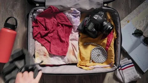 Packing suitcase before adventure travel Stock Footage