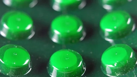 Packing tablets in a green blister. Macro. Moving on the slider camera Stock Footage 73828376