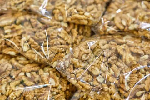 Packing from a transparent bag with walnuts. Stock Photos