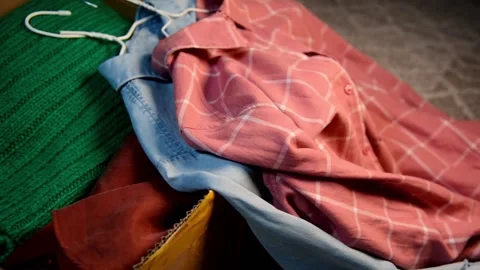 Packing used clothes in box. Video stock 147053939
