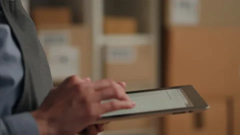 Packing, Warehouse worker Confidently holding electronic tablet in online st Stock Footage 233525388