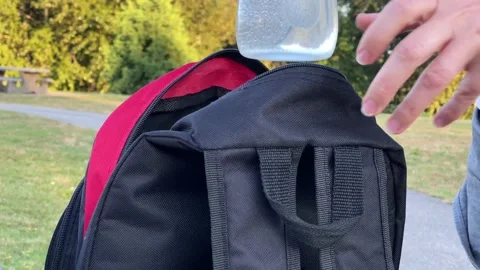 Packing Water Bottle. Close Up. Stock Footage 136448673