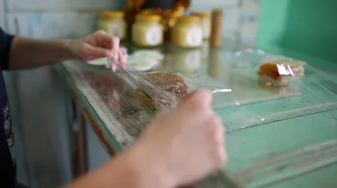 Packs honeycomb in cellophane. Close-up Stock Footage 58958366