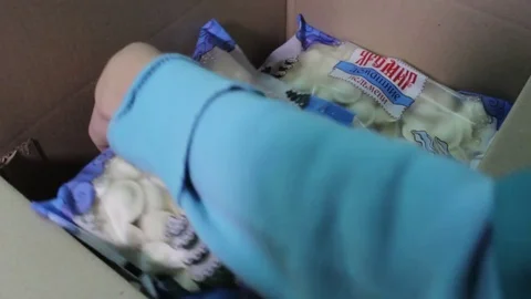 Packs of meat dumplings in a box, a packing line for meat dumplings, a close-up Stock Footage 75255437
