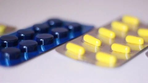 Packs with pills on white surface Vídeo Stock 88764370