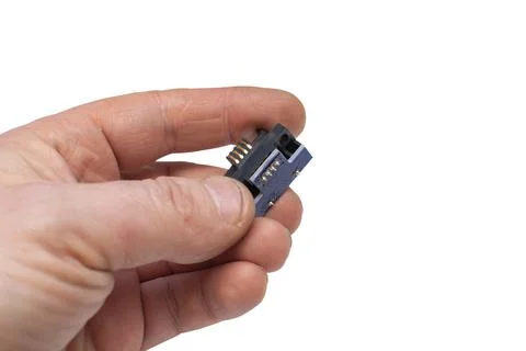 A pad with a chip, a microchip with copper contacts in a person hand Foto stock