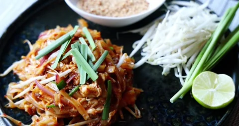 Pad Thai Dish Served with Garnishes on Dark Plate Stock Footage 323728526