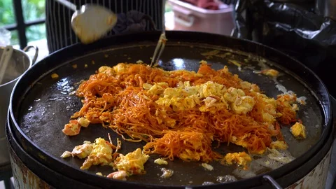 Pad Thai (Phad Thai), is stir fried rice noodle dish commonly served as a street Stock Footage 128409360