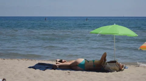 Paddle Board And Sunbathing At The Beach Stock Footage 53185712