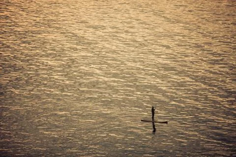 Paddle boarder on lake Stock Photos