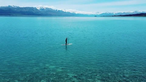 Paddle boarder with Mount Cook behind them Stock Footage 260369056