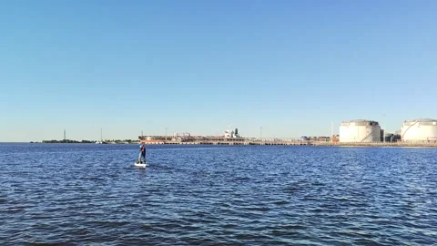 A paddle boarder sails on a sup board in the port of St. Petersburg. Stock-Footage 250191315