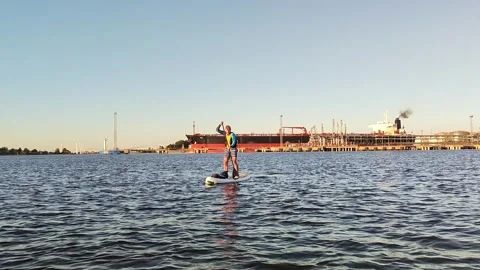 A paddle boarder sails on a sup board in the port of St. Petersburg. Stock-Footage 250191327