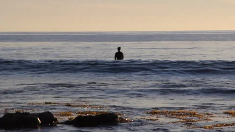 Paddle Boarder In Silhouette Meditates On The Waves Stock Footage Video stock 258511193