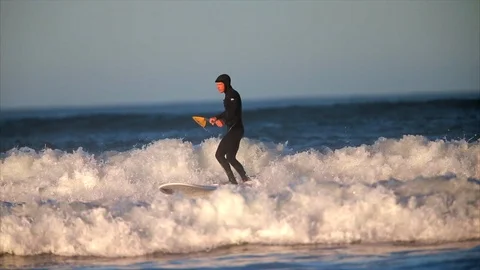 Paddle boarder surfing in the waves. 스톡 동영상 88406076