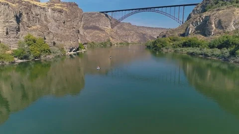 Paddle boarders on the left with bridge reflection Stock Footage 126601719