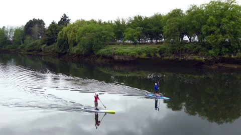Paddle boarding on the river Stock Footage 143925693