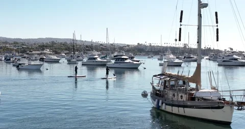 Paddle Boarding by Sailboat Stock Footage 230488190