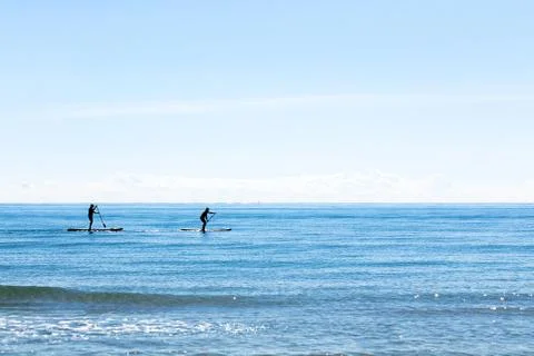 Paddle boarding silhouettes Stock Photos