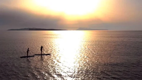Paddle boarding at sunset Stock Footage 91495625