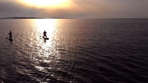 Paddle boarding at sunset Stock Footage 91495723