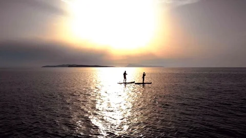 Paddle boarding at sunset Stock Footage 91495764