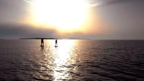 Paddle boarding at sunset Stock Footage 91495774