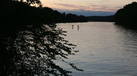 Paddle boarding at twilight time lapse Stock Footage 42549539