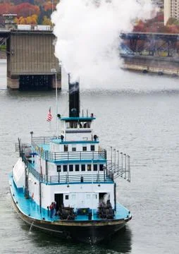 Paddle boat heading down river Stock Photos